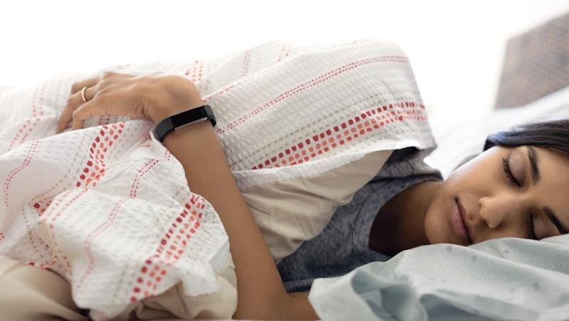 Alta HR lifestyle shot featuring a young Indian woman wearing the black classic band while sleeping.